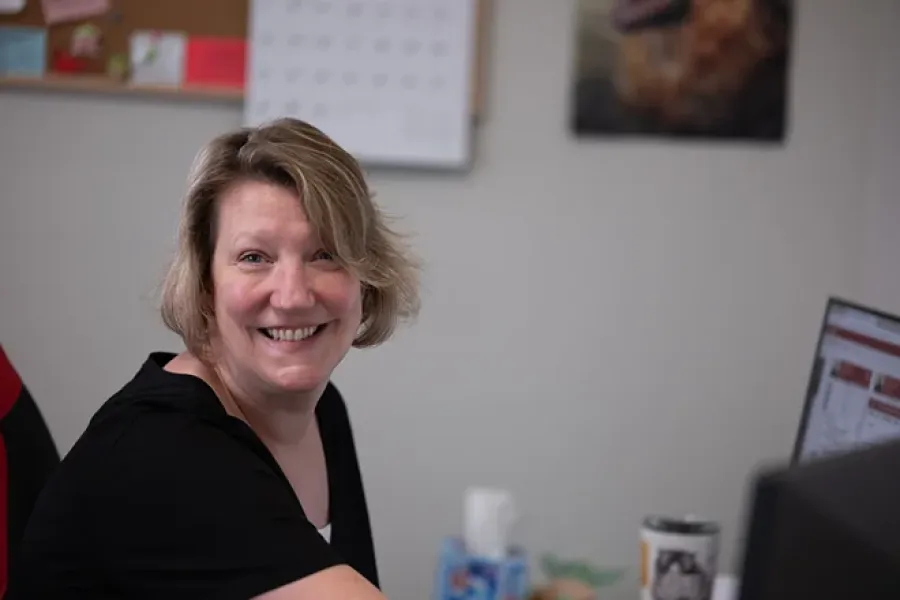 D-Bug Pest team member in the office smiling