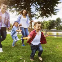 family running outside of their greensburg home