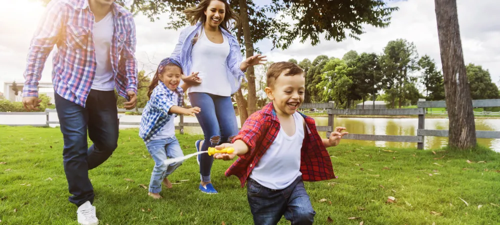 family running outside of their greensburg home